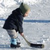 Little kid playing pond hockey