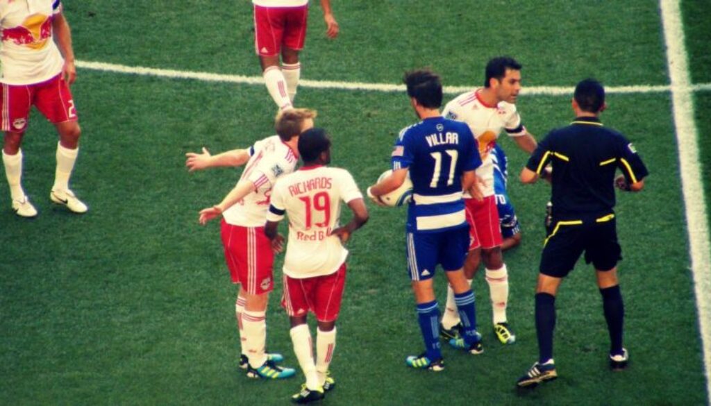 Soccer Players arguing with the ref