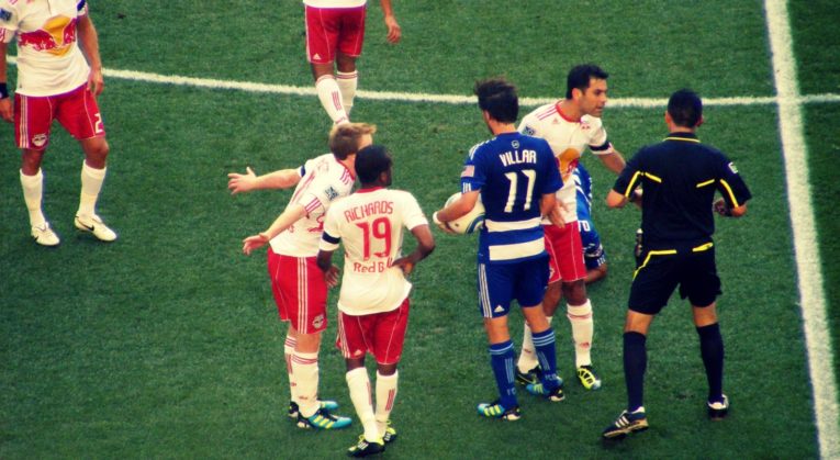 Soccer Players arguing with the ref