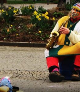 A clown playing a saxaphone