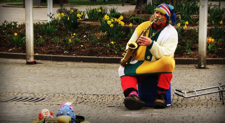 A clown playing a saxaphone