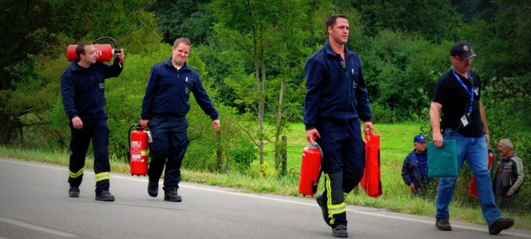 fireman carrying fire extinguishers.jpg