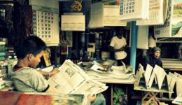 boy reading the paper learning new information