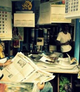 boy reading the paper learning new information