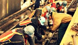 workers putting rail line in build a strengths based team
