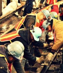 workers putting rail line in build a strengths based team