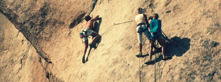 strong people rock climbing
