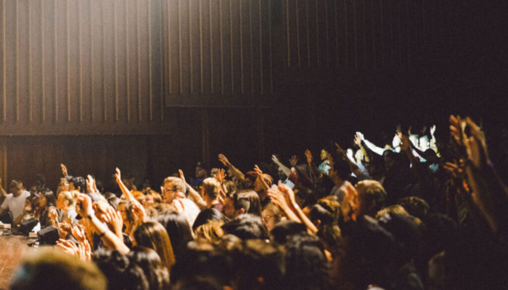 conference-crowd-raising-their-hands