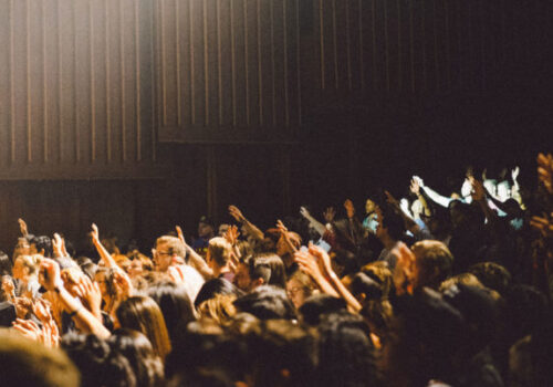 conference-crowd-raising-their-hands