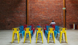 man-alone-in-room-with-chairs