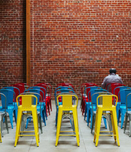 man-alone-in-room-with-chairs