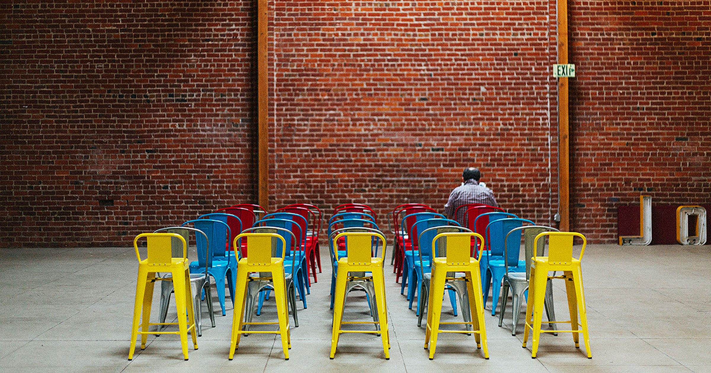 man-alone-in-room-with-chairs