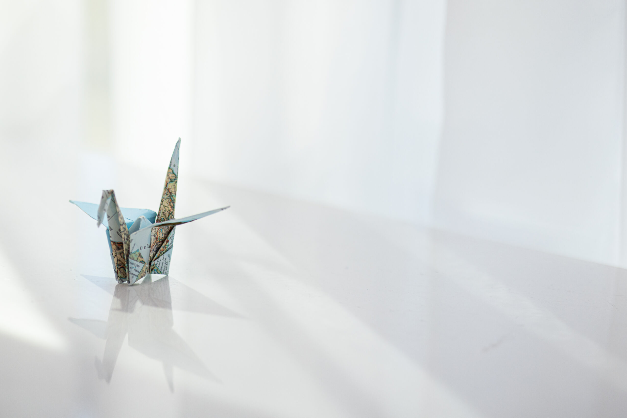 Origami crane folded from a map, symbolizing transformation